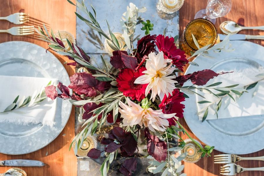 Beautiful floral arrangement with dahlias on a festive table setting, perfect for weddings.