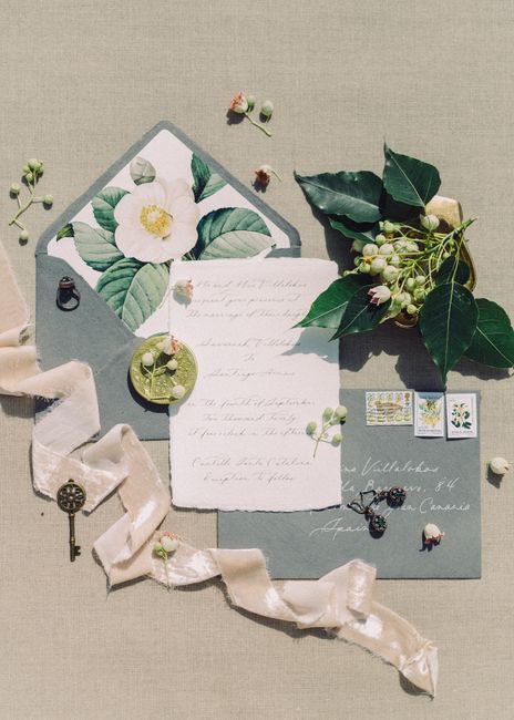 Chic vintage stationery set with handwriting, floral elements, and decorative key on neutral backdrop.