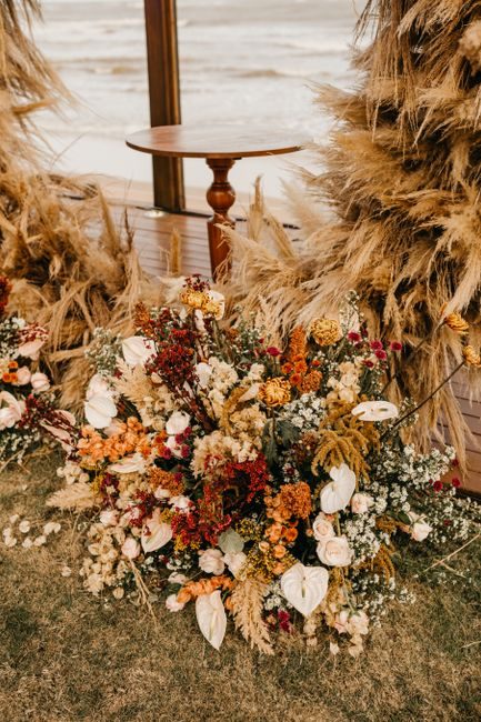 Stunning autumn floral display with rustic vibes by the beach, perfect for seasonal events.