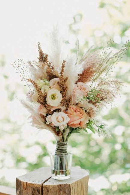 Beautiful bouquet of dried and fresh flowers in soft pastel colors, perfect for home decor.