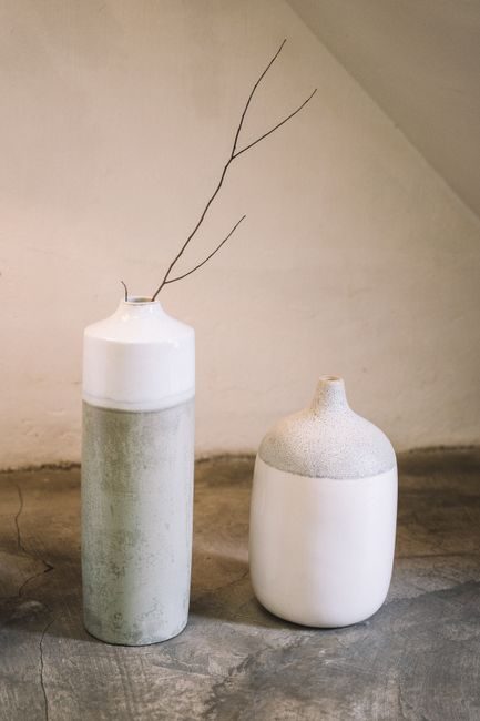 Minimalist ceramic vases with a branch for stylish home decor.